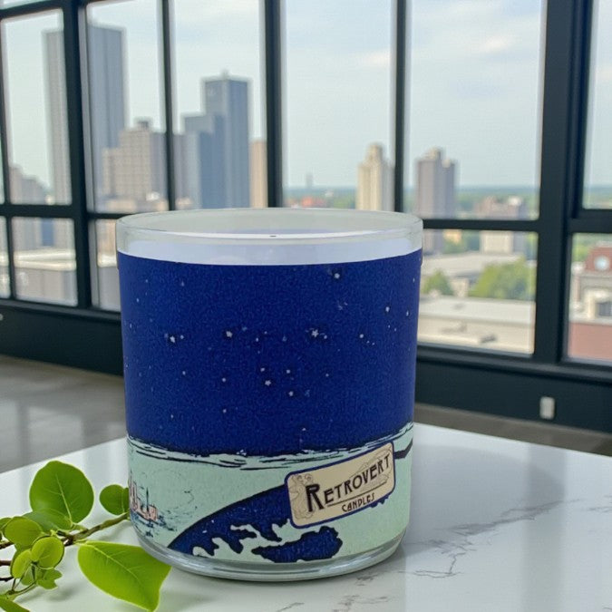 Candle with blue label and 'Retrovert Candles' branding in front of a cityscape