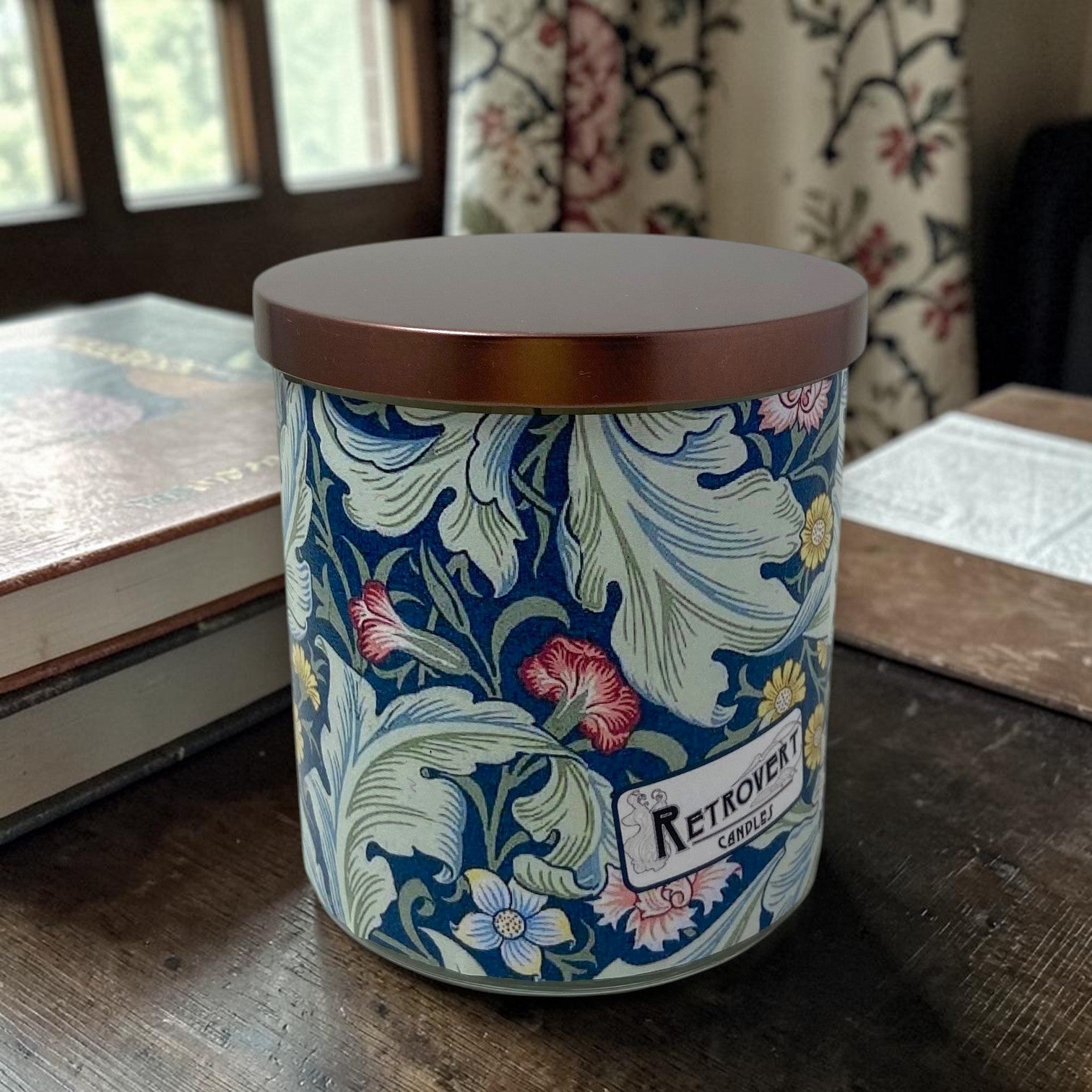 Decorative Wiliam Morris candle with floral design and 'Retrovert Candles' branding on a wooden surface.