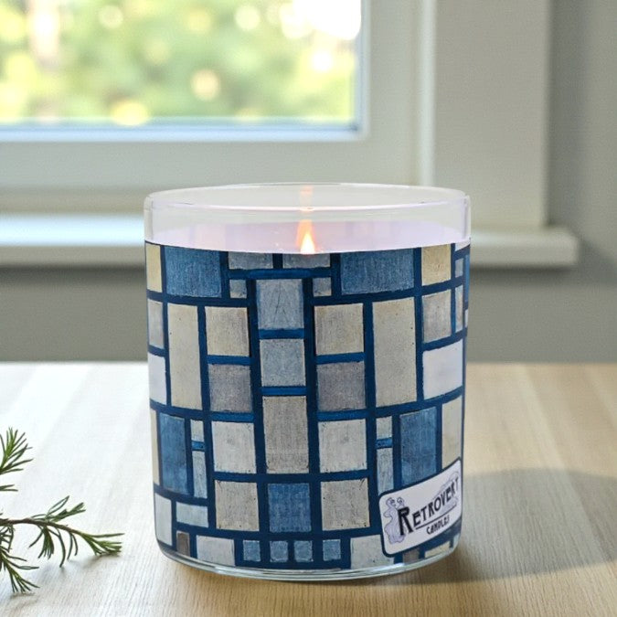 Candle with a blue and white patterned container on a table