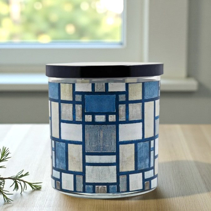 Candle jar with blue and white geometric pattern on a surface