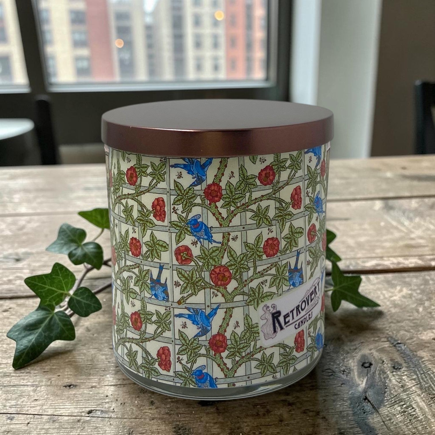 Candle jar with decorative label on a wooden surface