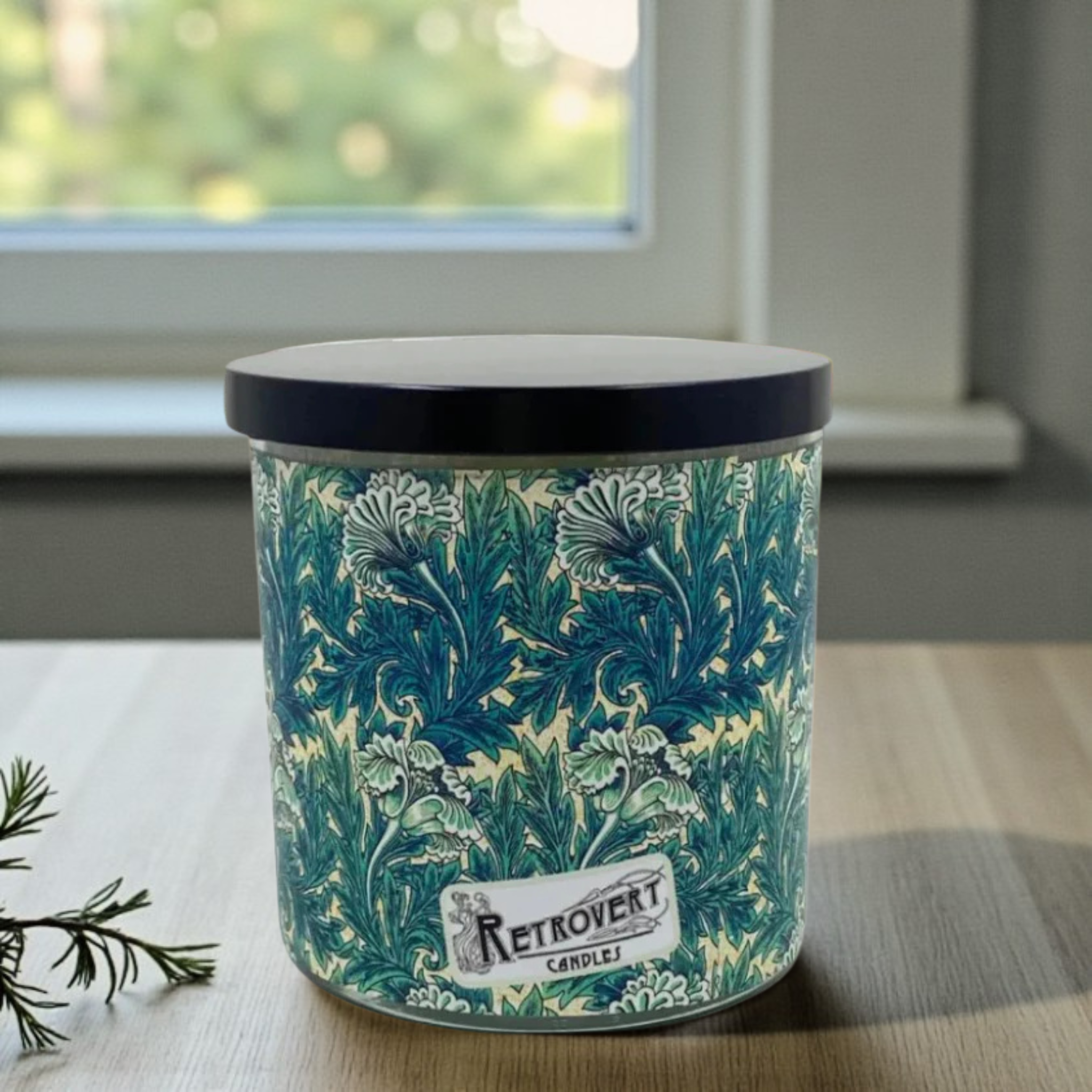 Candle jar with floral pattern and 'Retrovert' label on a surface.