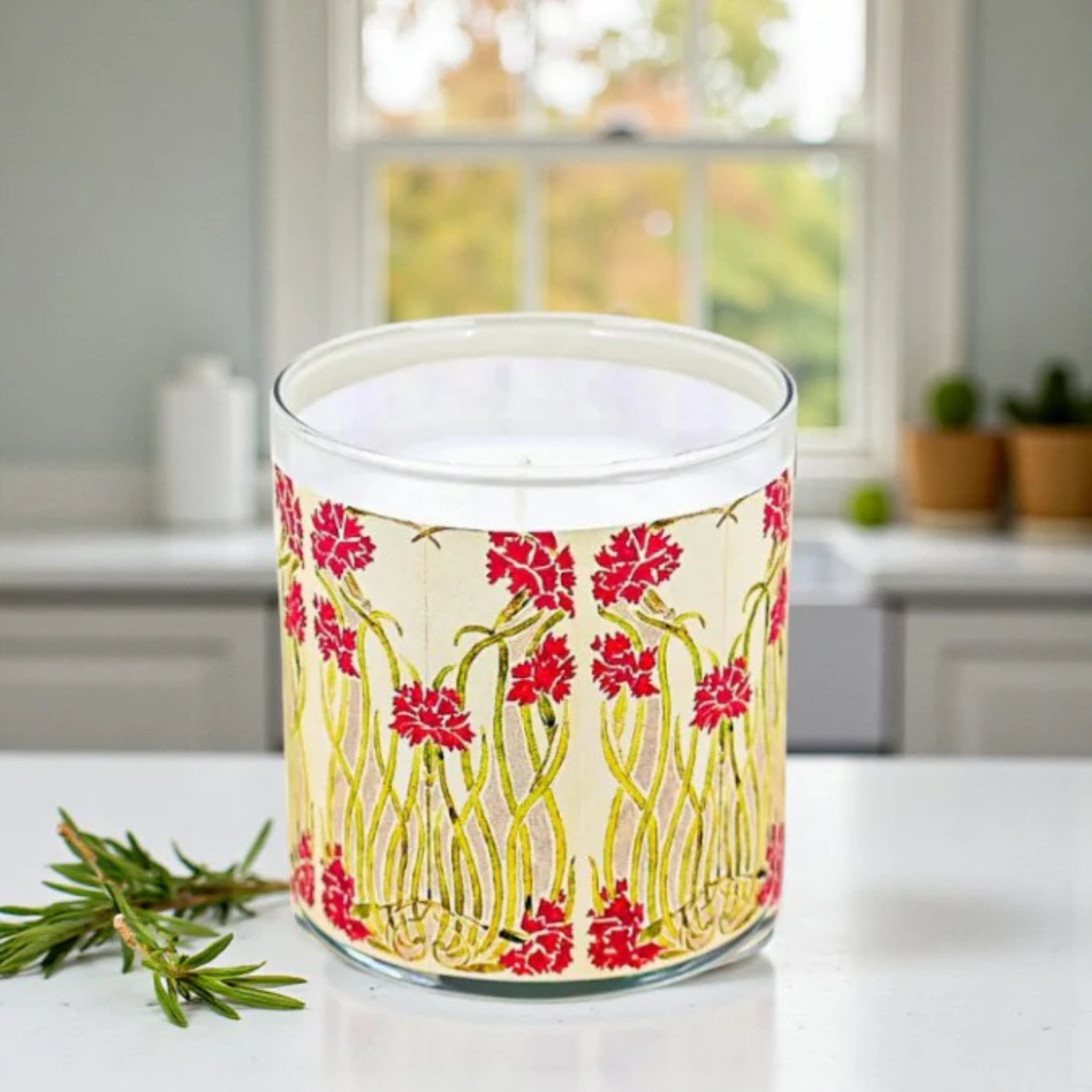 Candle with floral design on a kitchen counter