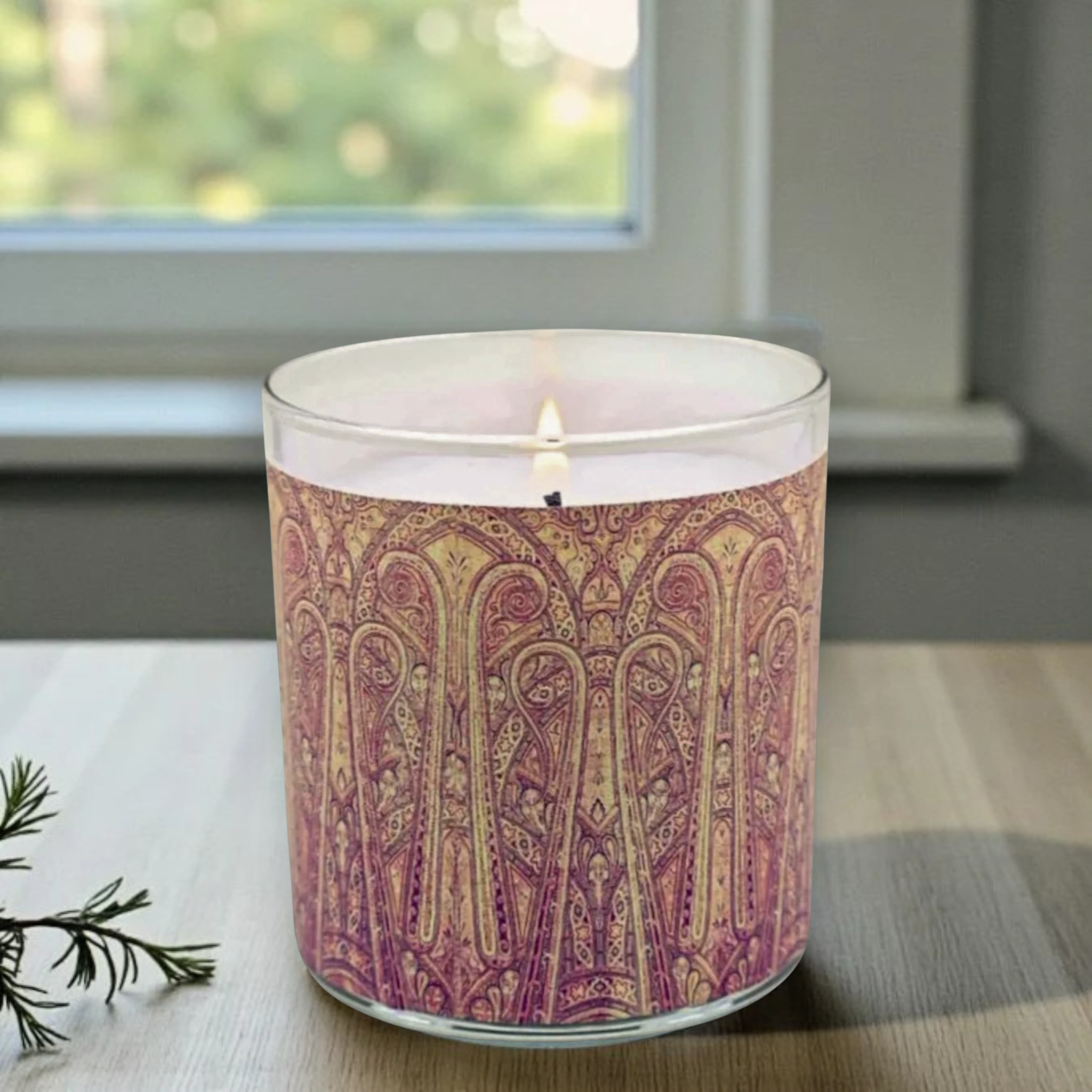 Candle with a patterned label on a surface near a window