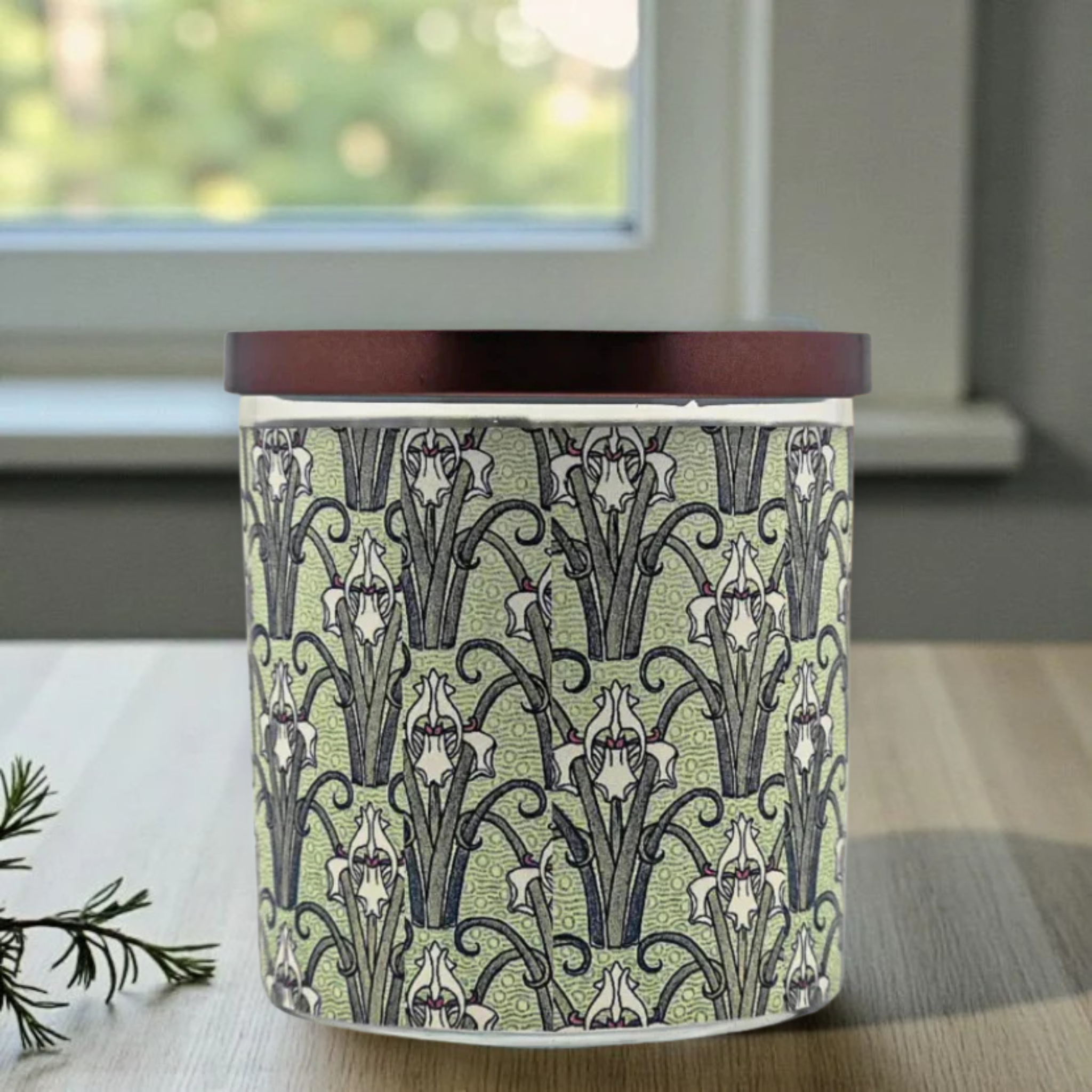 Candle with decorative pattern on a surface near a window