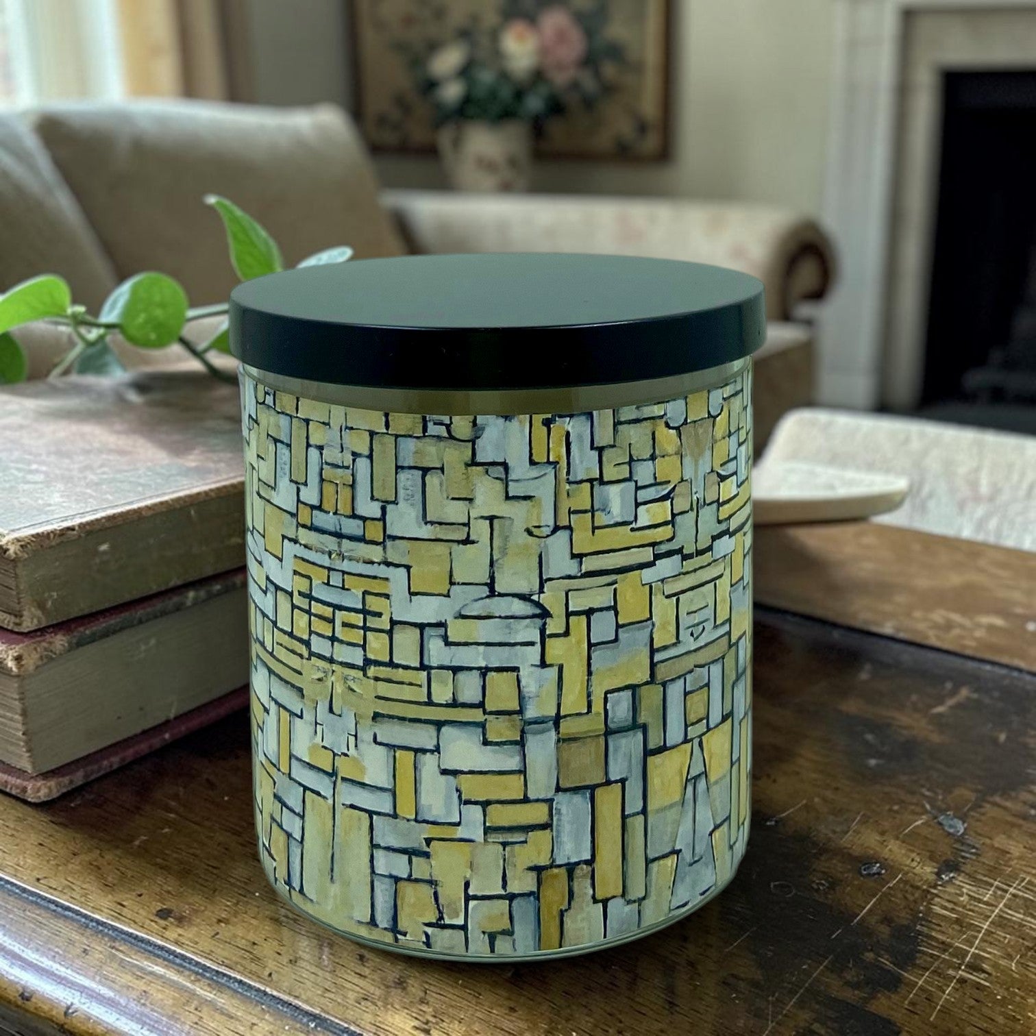 Cylindrical container with geometric pattern on a wooden surface in a home setting