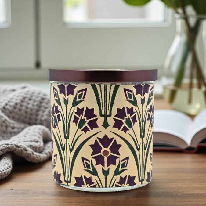Decorative candle with floral pattern on a wooden surface