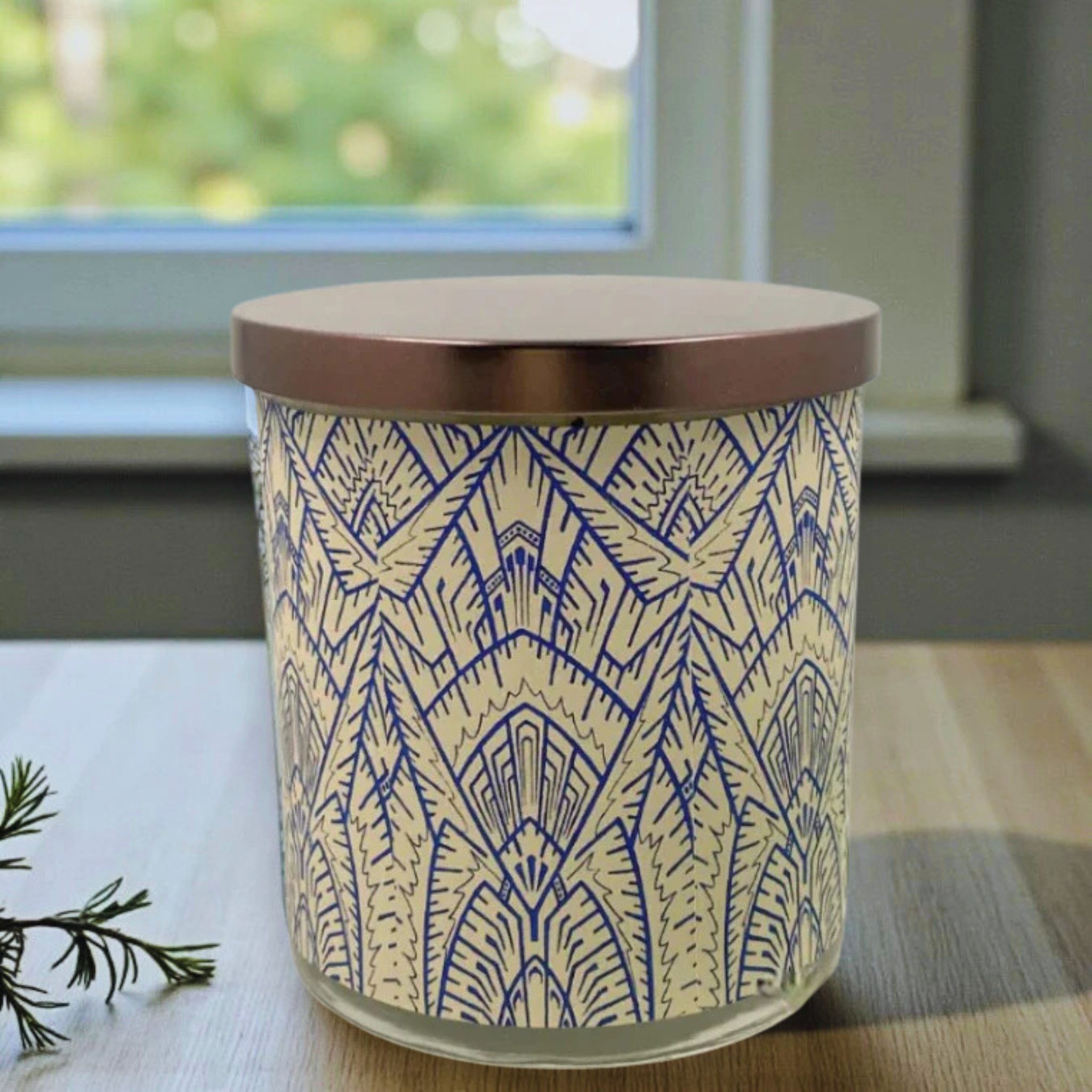 Cylindrical container with blue geometric pattern on a wooden surface