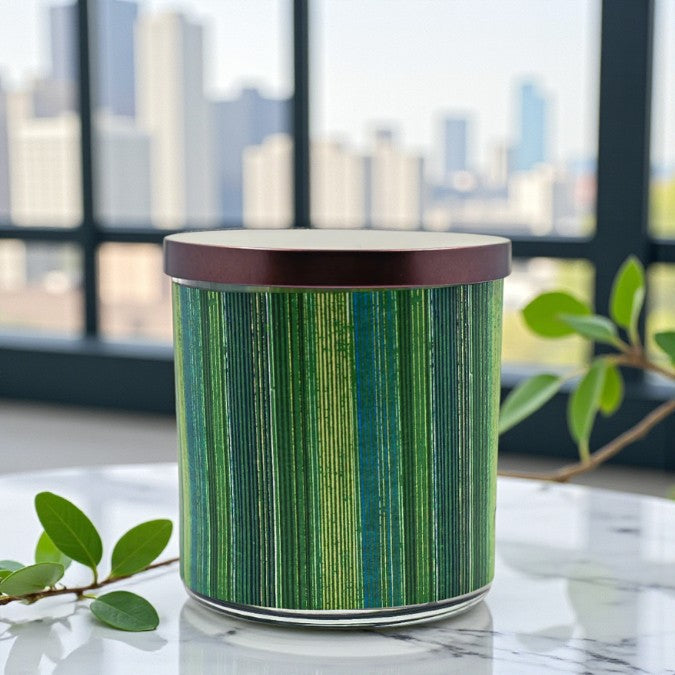 Green cylindrical container with a wooden lid on a marble surface with a cityscape background