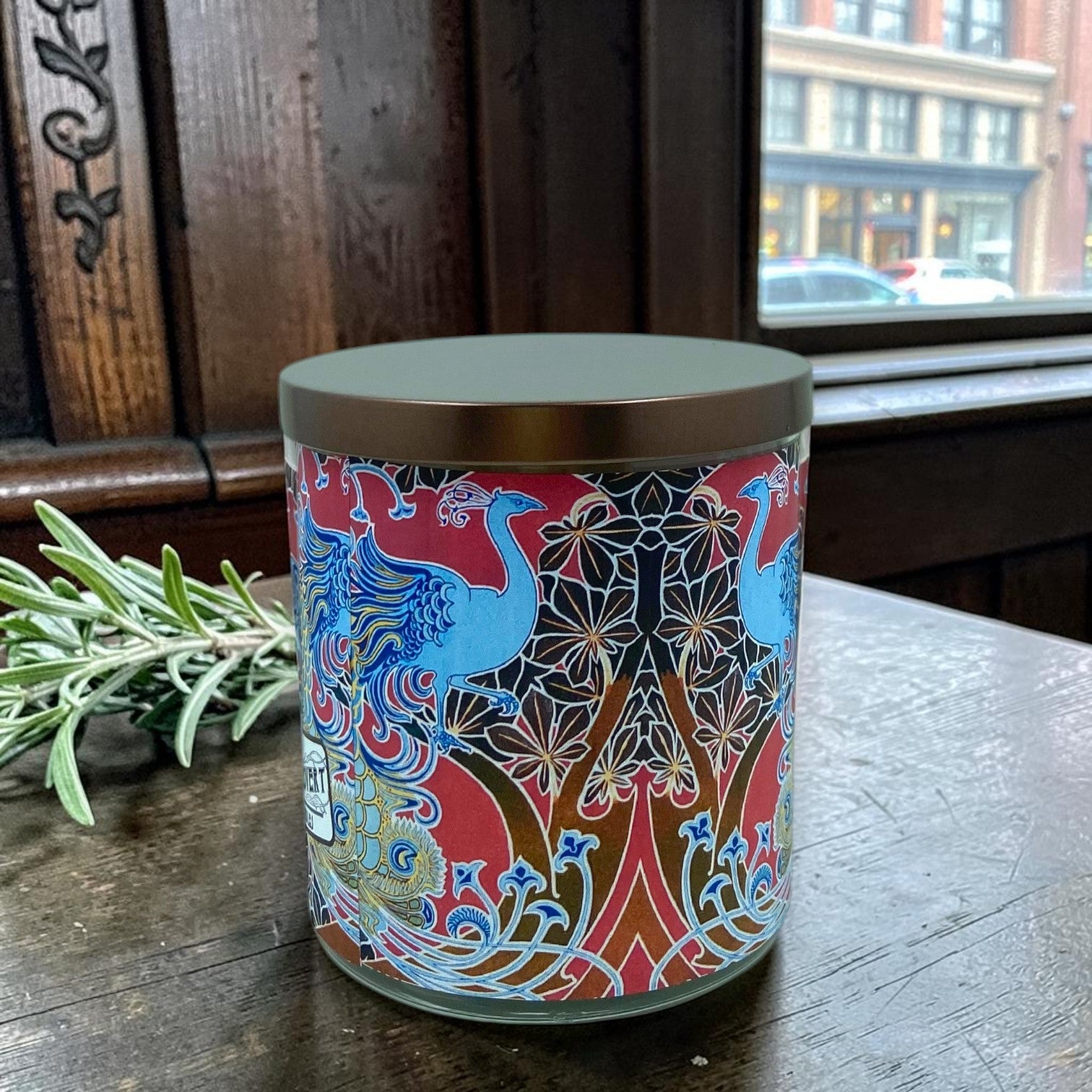 Decorative cylindrical container with intricate patterns on a wooden surface.