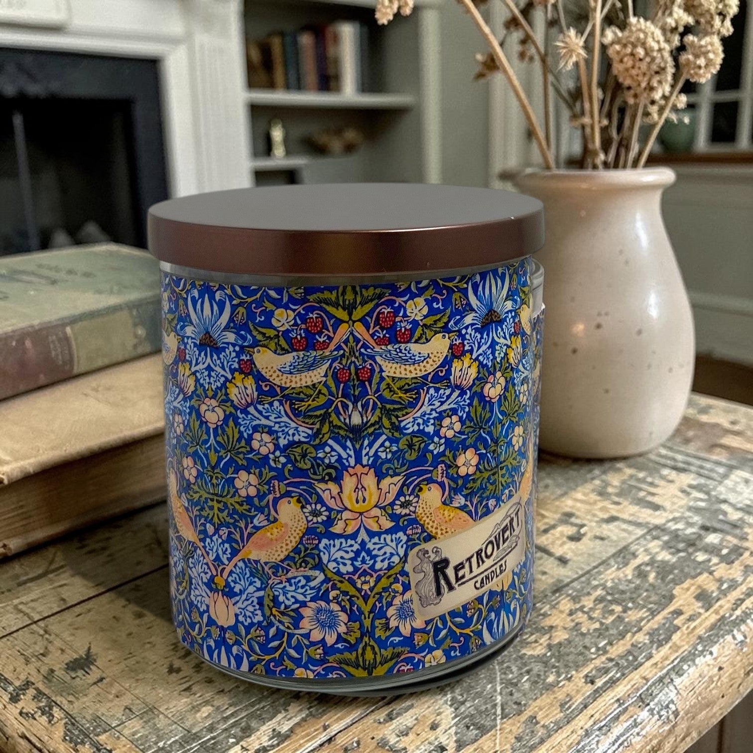 Decorative candle with floral pattern on a wooden surface